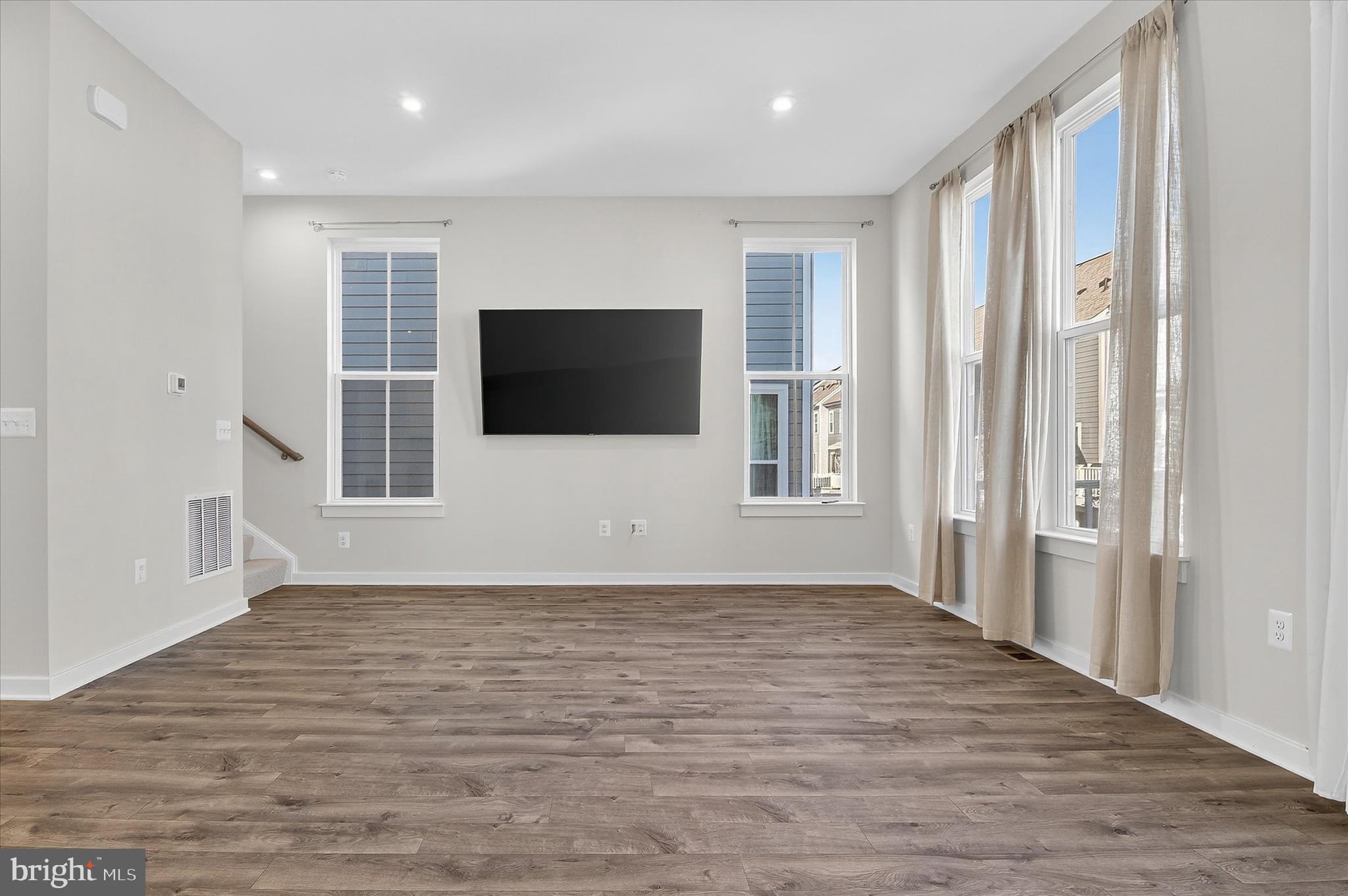 1681 Aspen Poplar Road Dumfries, VA 22026 - Photo 9 of 36 a view of a livingroom with wooden floor and a flat screen tv