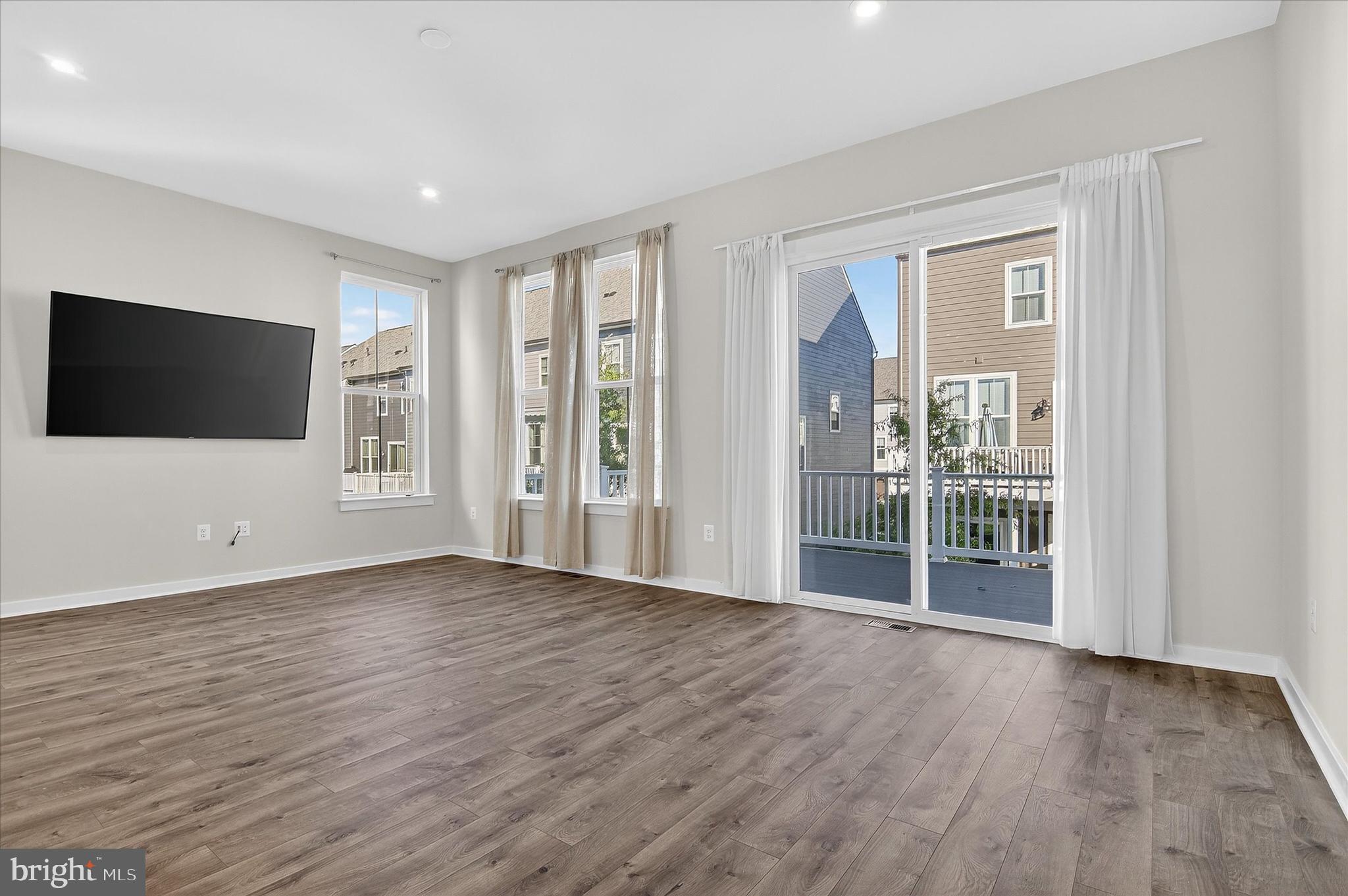 1681 Aspen Poplar Road Dumfries, VA 22026 - Photo 10 of 36 a view of a livingroom with wooden floor and a flat screen tv