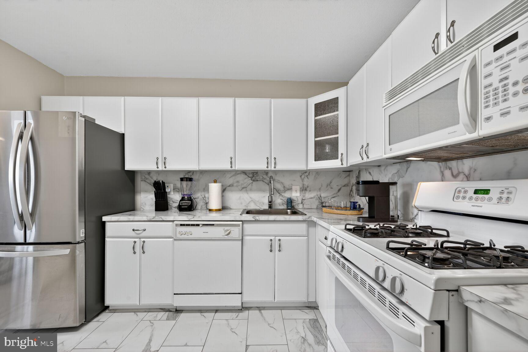 1121 University Boulevard West, Unit 1104B Silver Spring, MD 20902 - Photo 15 of 28 Updated Kitchen - White Cabinets