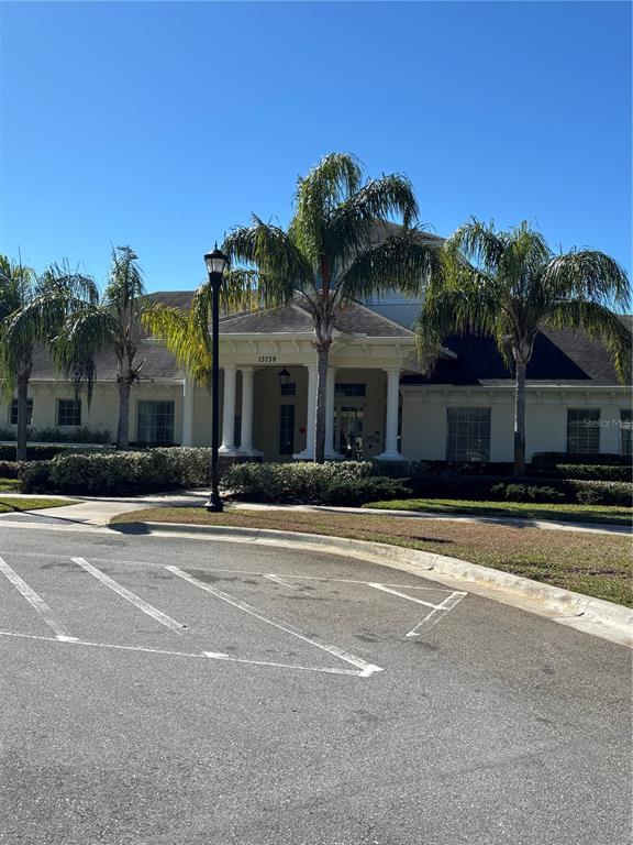 13719 Eastfork Lane Hudson, FL 34669 - Photo 15 of 17 a view of a house with a yard and palm trees