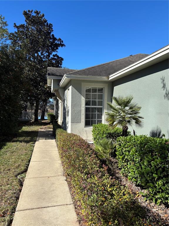13719 Eastfork Lane Hudson, FL 34669 - Photo 2 of 17 a front view of a house with garden