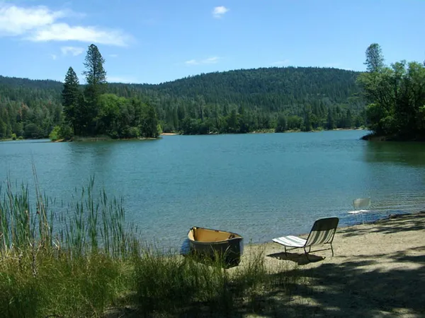 a view of a lake in middle of the green forest