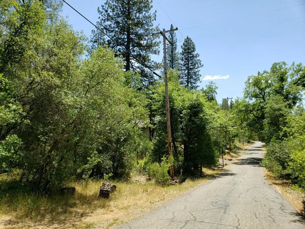 a view of a wooden house with a sign broad