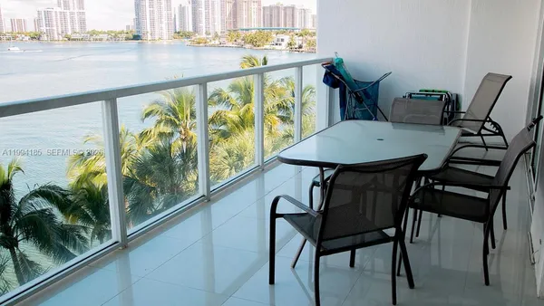 a view of a balcony with table and chairs