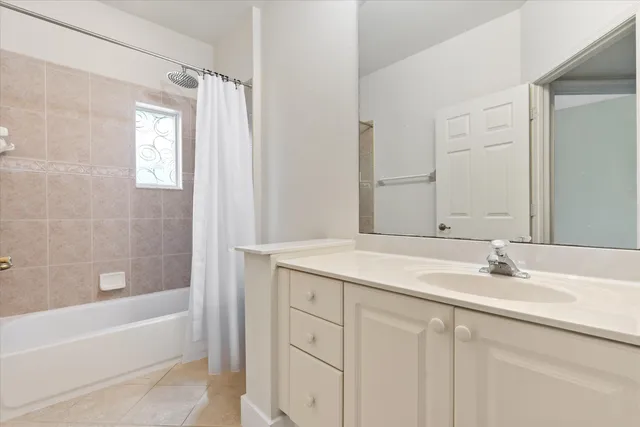 a bathroom with a tub sink and mirror