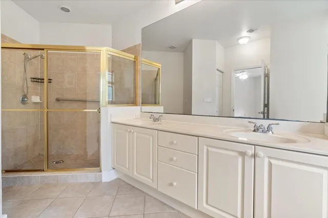 a bathroom with a shower sink and mirror