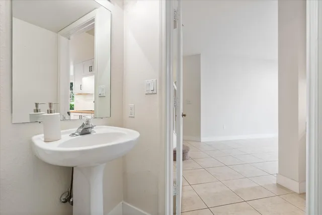 a bathroom with a sink a mirror and shower