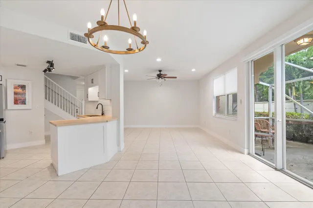 a view of a kitchen with furniture and chandelier