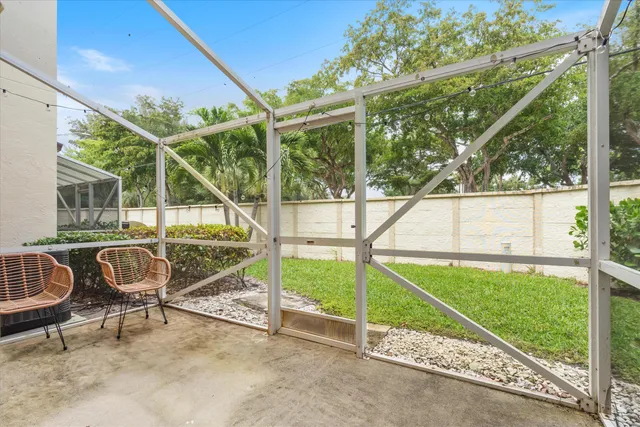 a house view with a bench and wooden fence