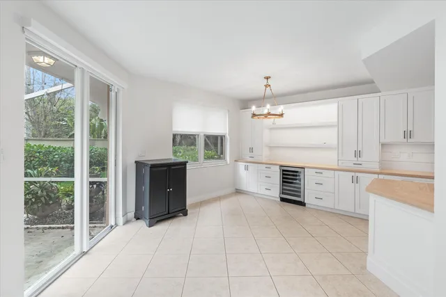 a large kitchen with cabinets and wooden floor