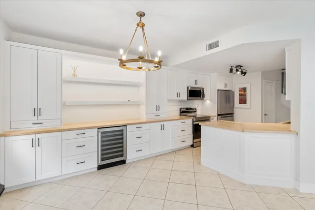 a kitchen with cabinets and chairs