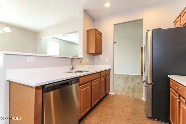 a kitchen with a sink and a refrigerator