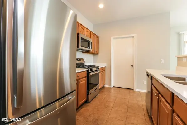 a kitchen with stainless steel appliances granite countertop a stove and a refrigerator