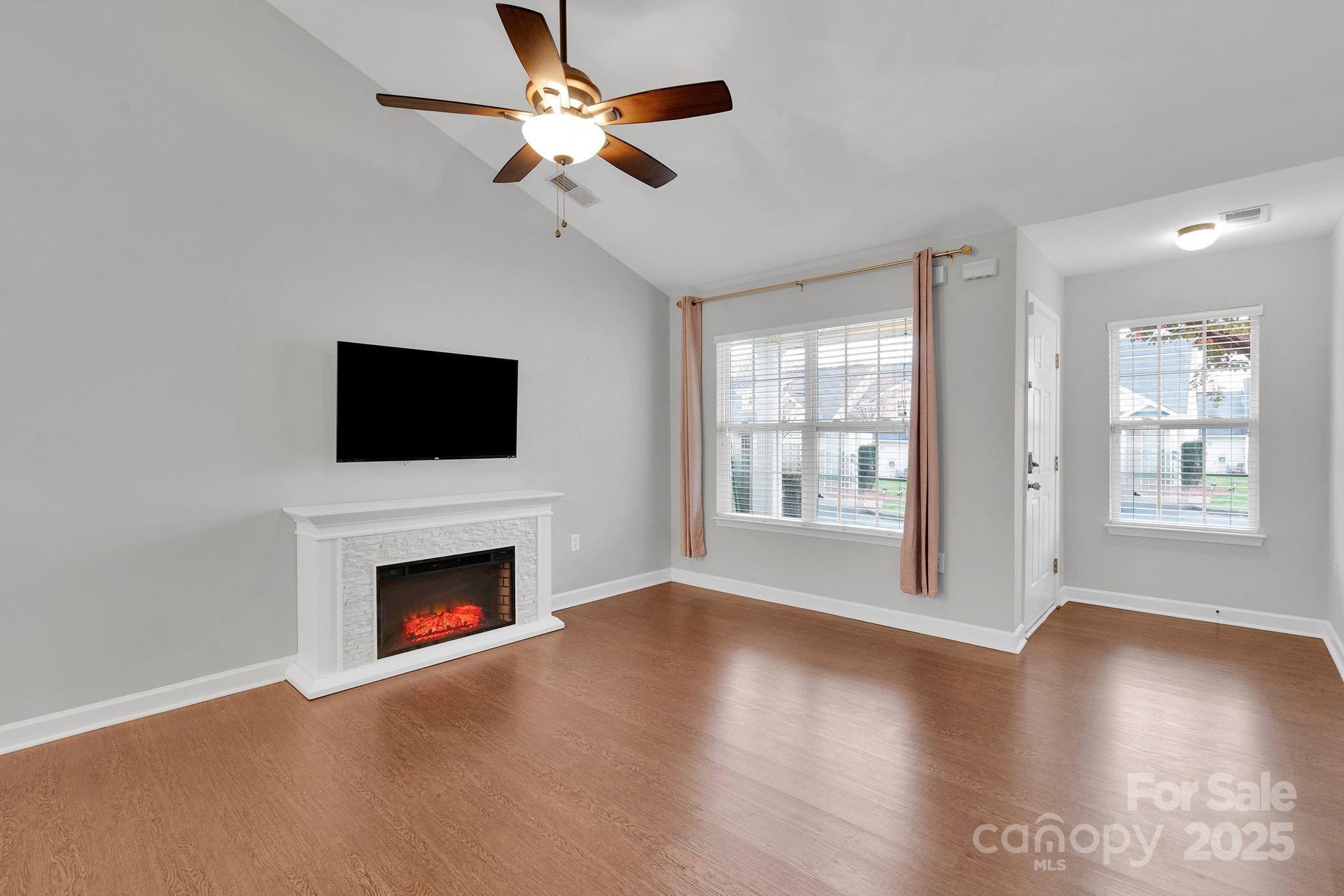 743 Waterfall Way Clover, SC 29710 - Photo 4 of 20 a view of an empty room with wooden floor fireplace and a window