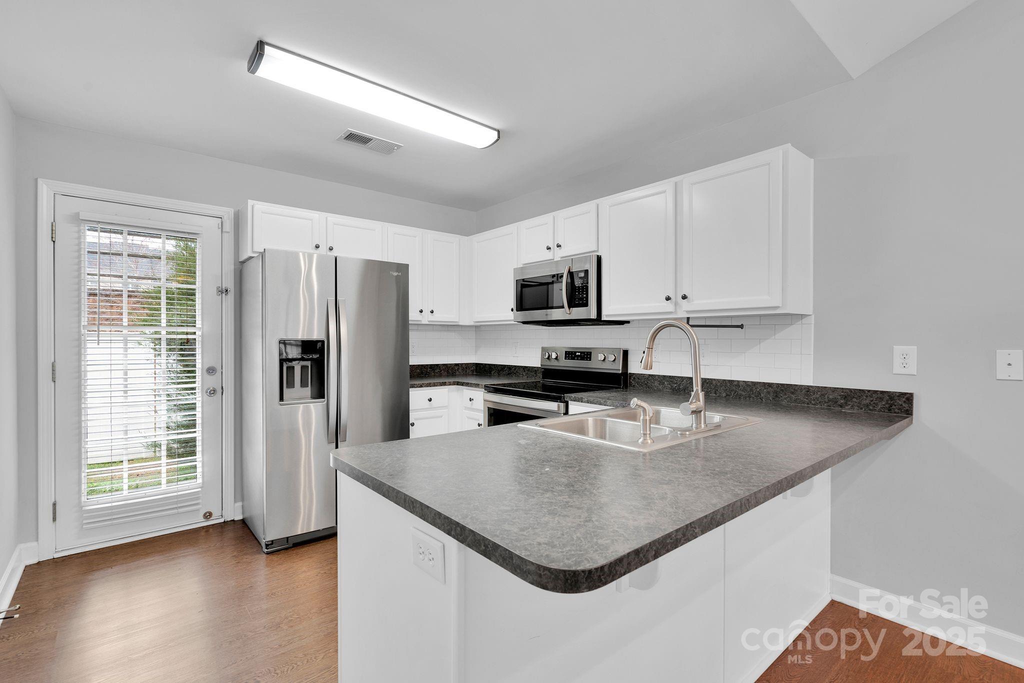 743 Waterfall Way Clover, SC 29710 - Photo 6 of 20 a kitchen with stainless steel appliances granite countertop a sink a microwave a refrigerator and a stove