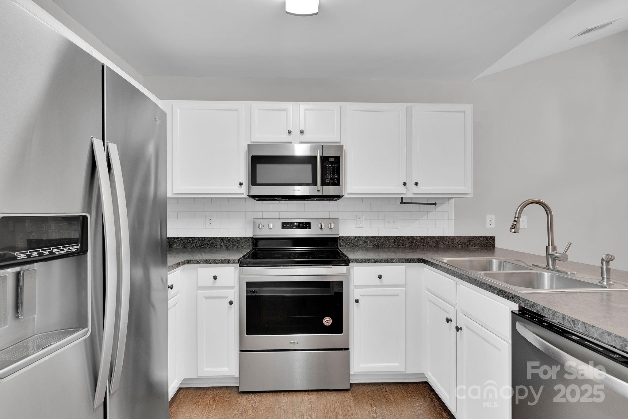 743 Waterfall Way Clover, SC 29710 - Photo 7 of 20 a kitchen with white cabinets stainless steel appliances and sink