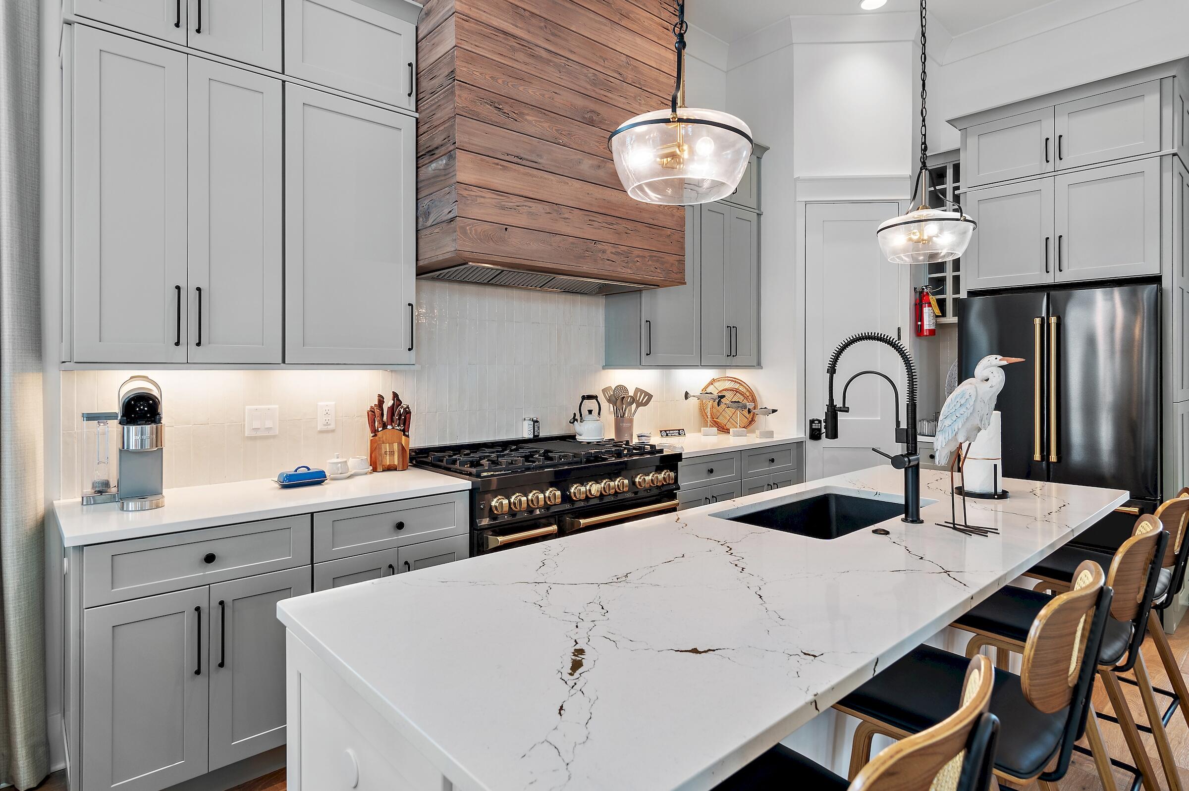71 Grande Pointe Drive Inlet Beach, FL 32461 - Photo 18 of 48 a kitchen with a sink a stove and chairs