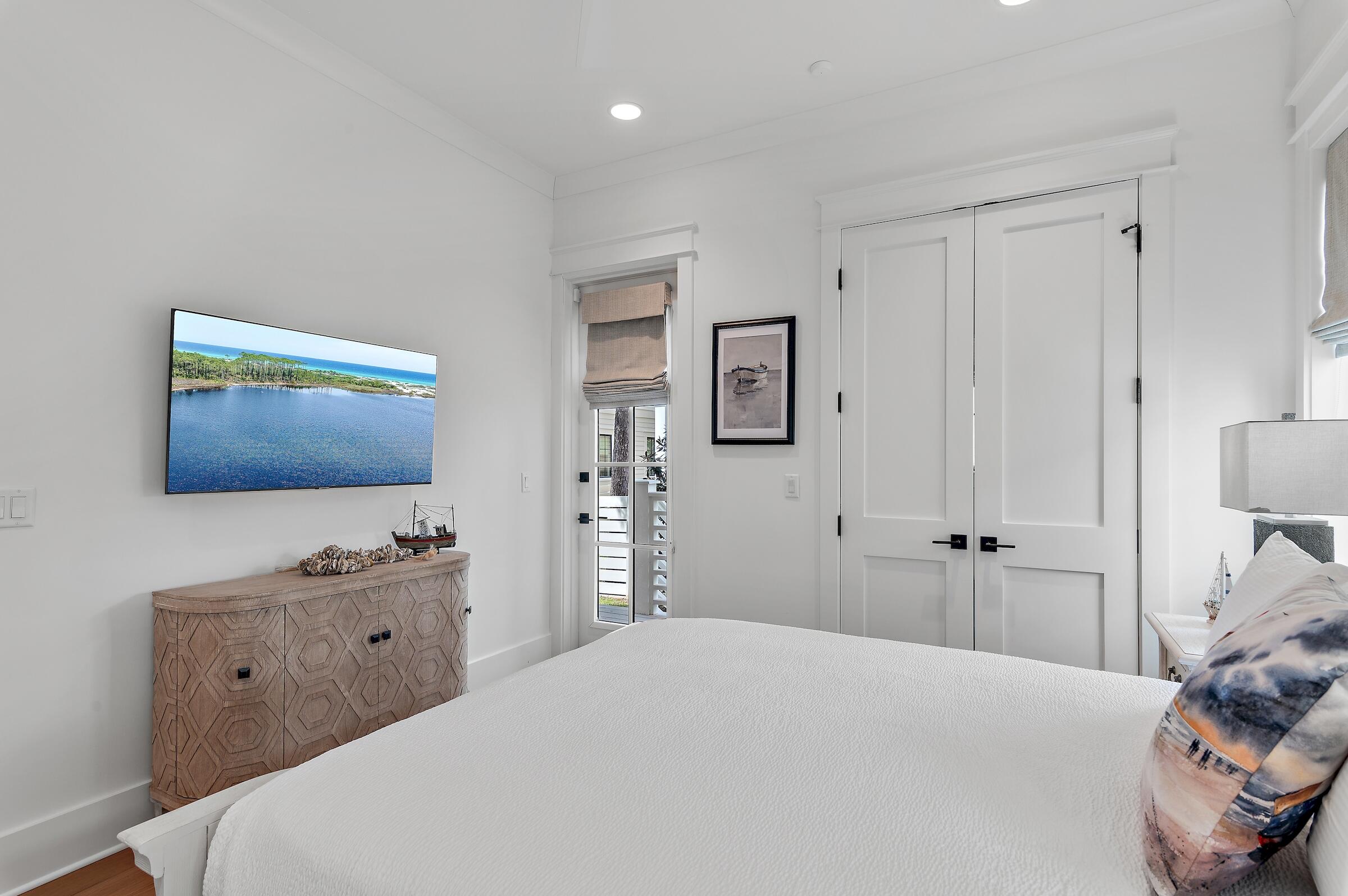 71 Grande Pointe Drive Inlet Beach, FL 32461 - Photo 43 of 48 a bedroom with a bed and a flat screen tv