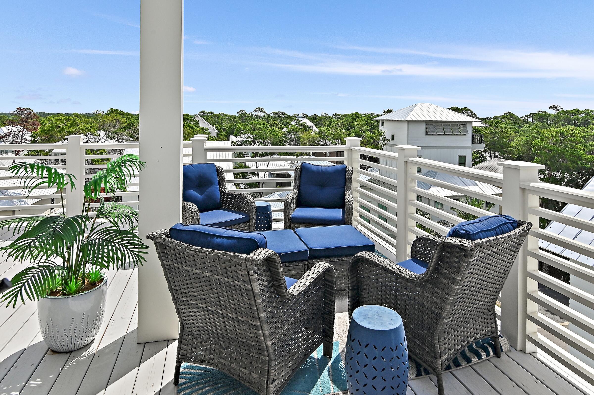71 Grande Pointe Drive Inlet Beach, FL 32461 - Photo 7 of 48 a view of a balcony with chairs and a potted plant