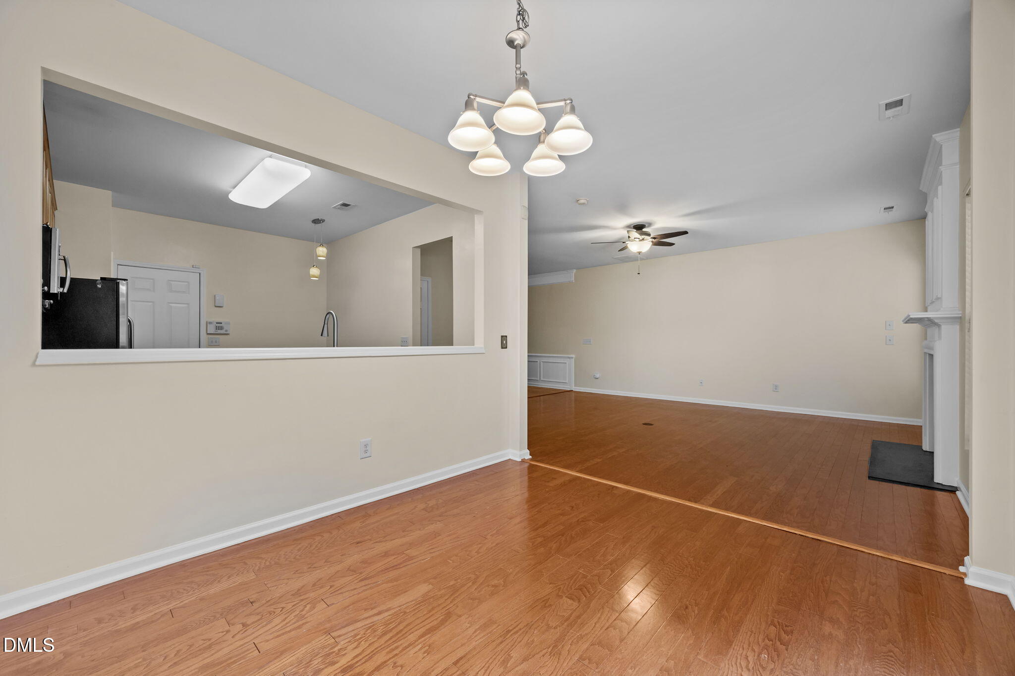 7805 Jeffrey Alan Court Raleigh, NC 27613 - Photo 13 of 46 a view of a room with wooden floor and chandelier