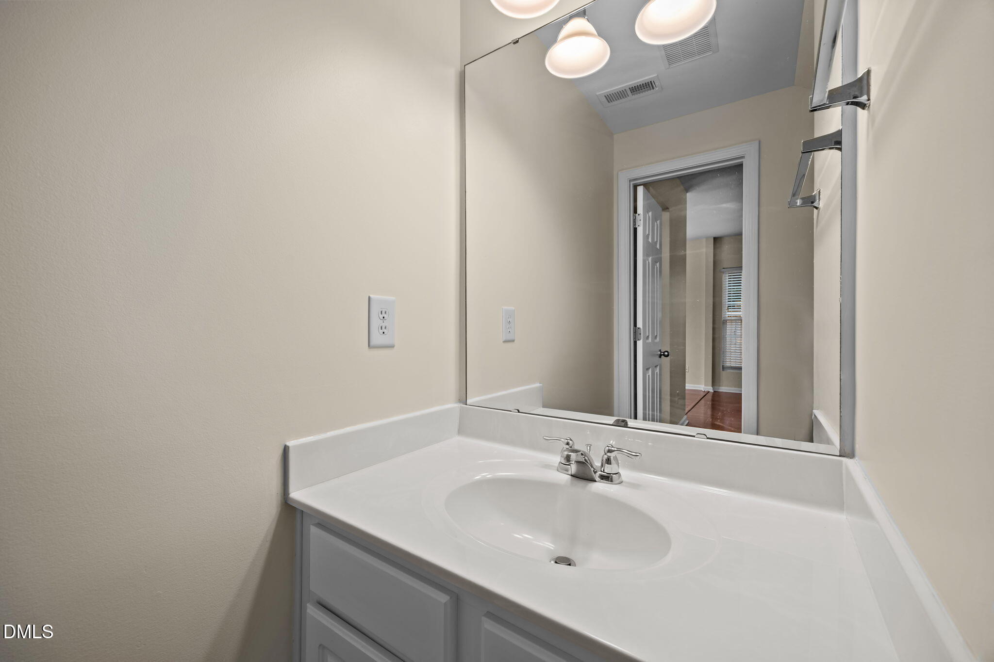 7805 Jeffrey Alan Court Raleigh, NC 27613 - Photo 19 of 46 a bathroom with a sink and a mirror