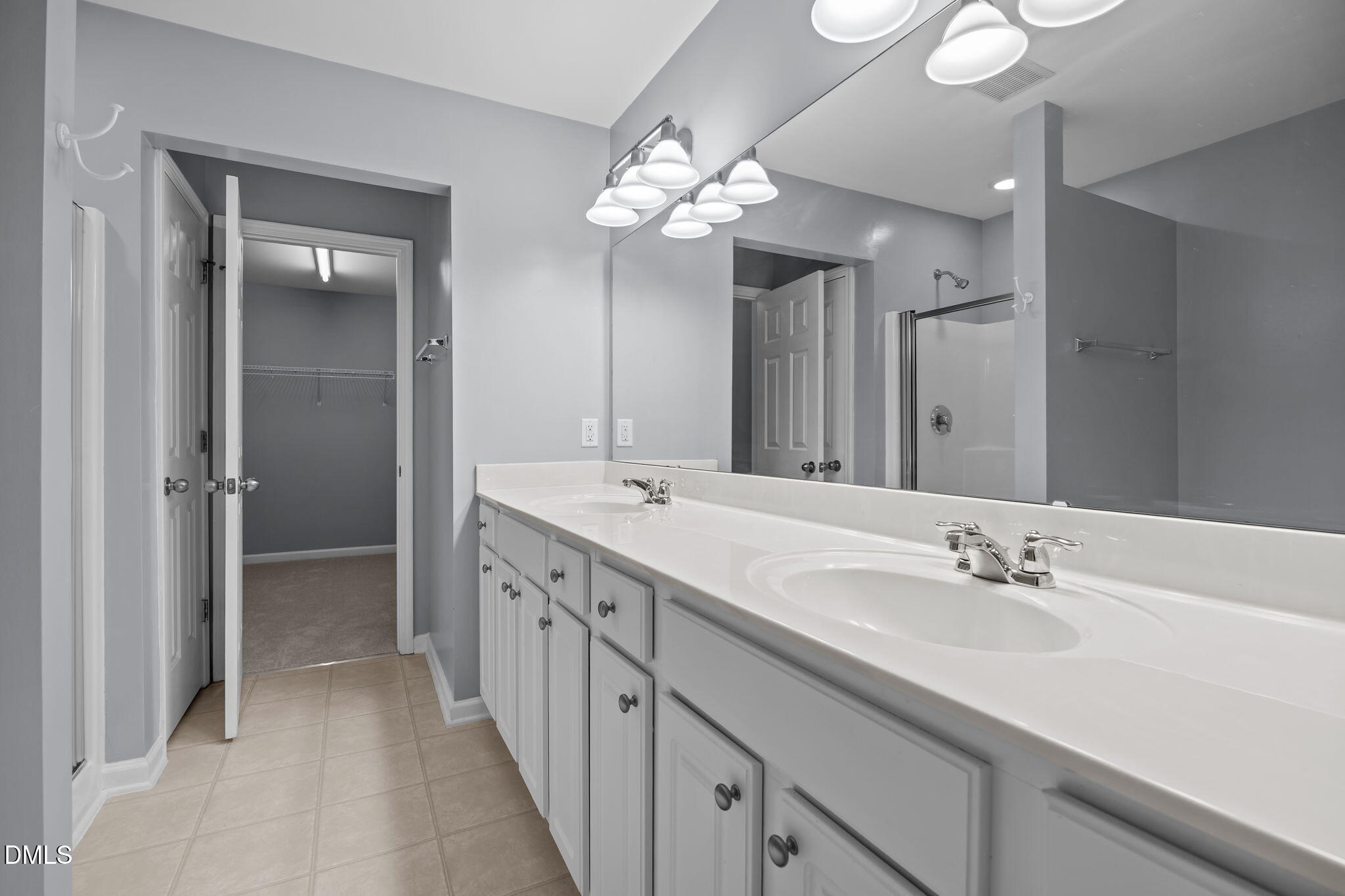 7805 Jeffrey Alan Court Raleigh, NC 27613 - Photo 23 of 46 a bathroom with a double vanity sink and a mirror