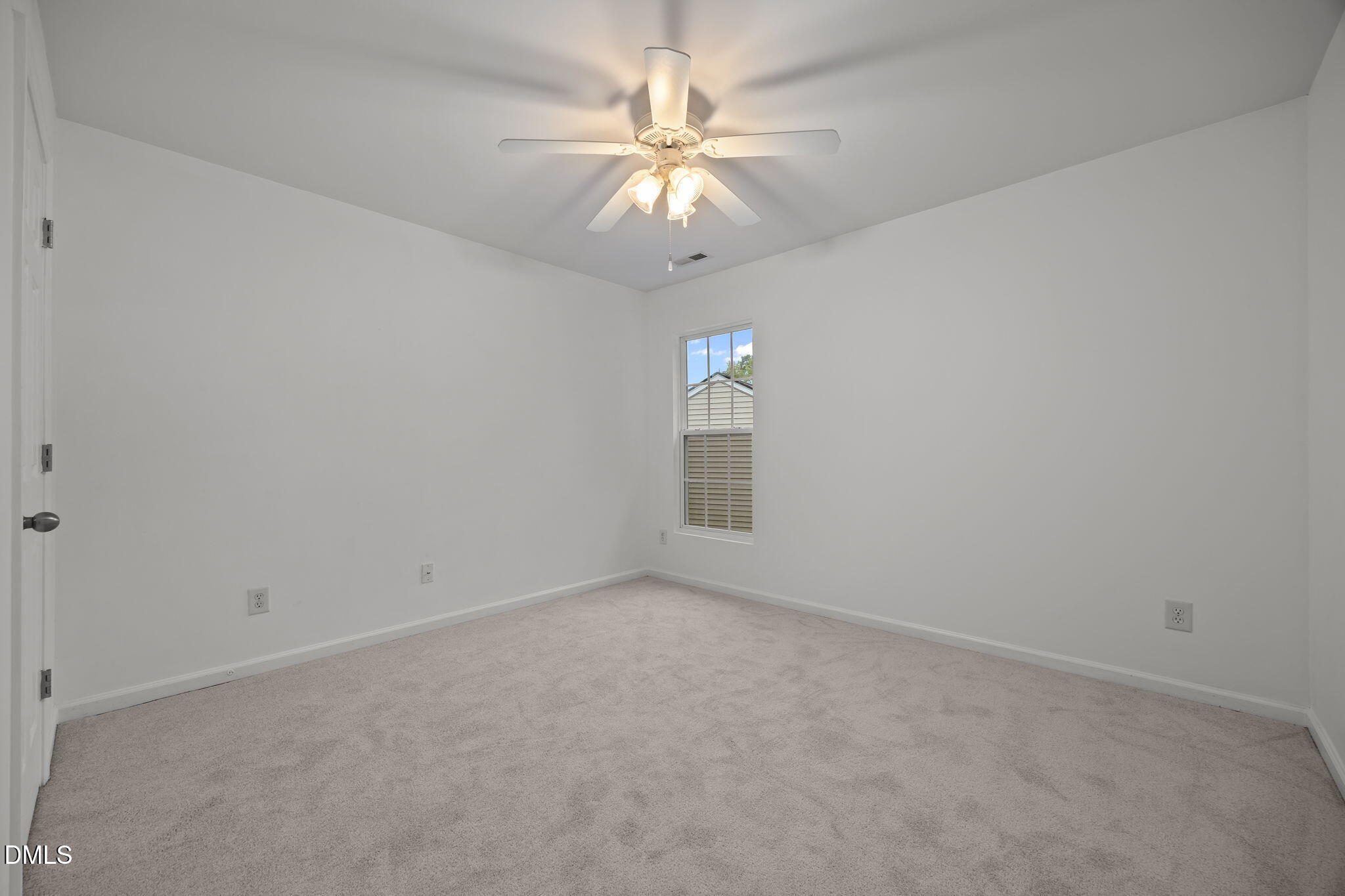 7805 Jeffrey Alan Court Raleigh, NC 27613 - Photo 28 of 46 an empty room with a chandelier fan and windows