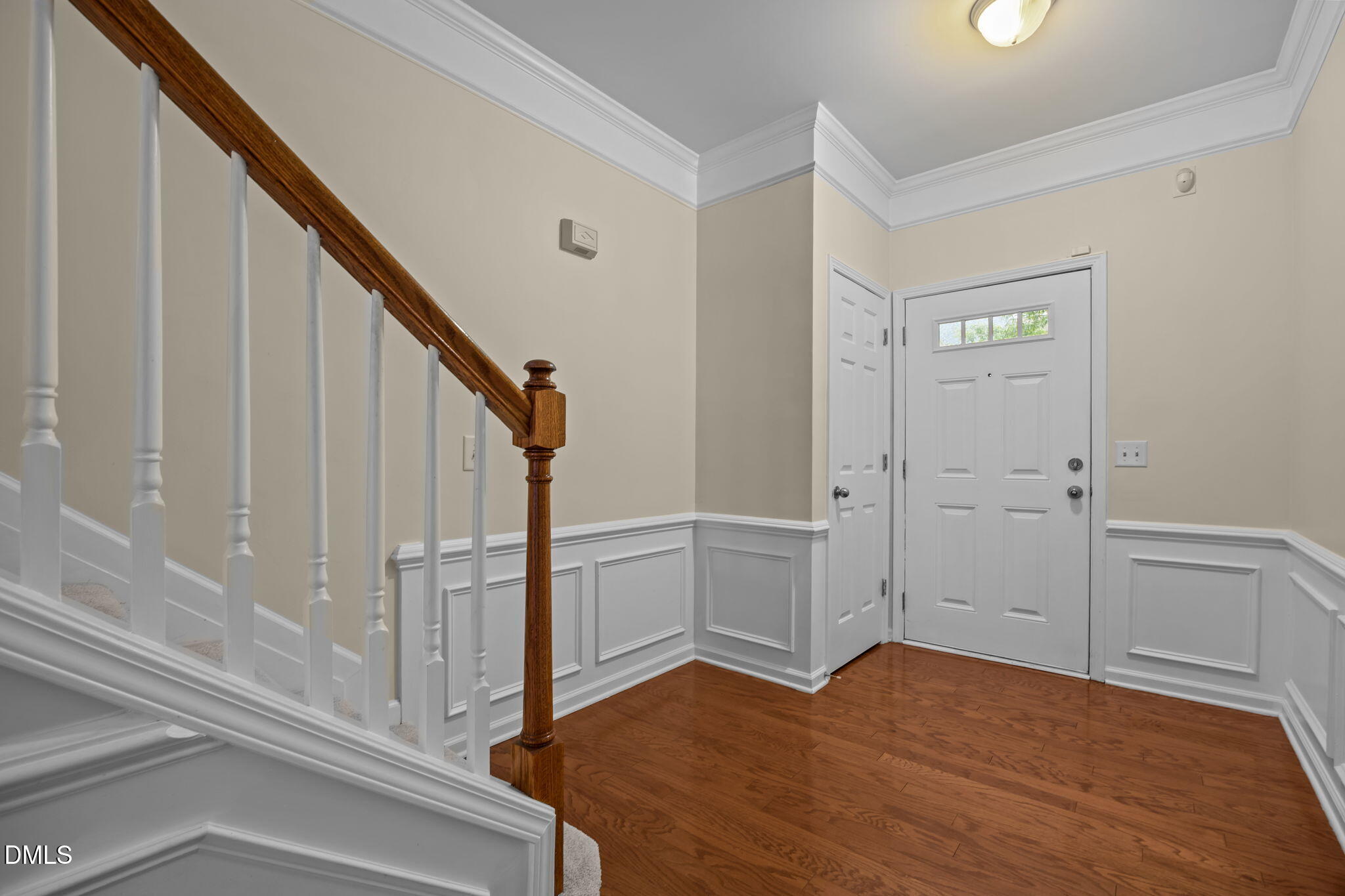 7805 Jeffrey Alan Court Raleigh, NC 27613 - Photo 5 of 46 a view of a hallway with wooden floor and staircase
