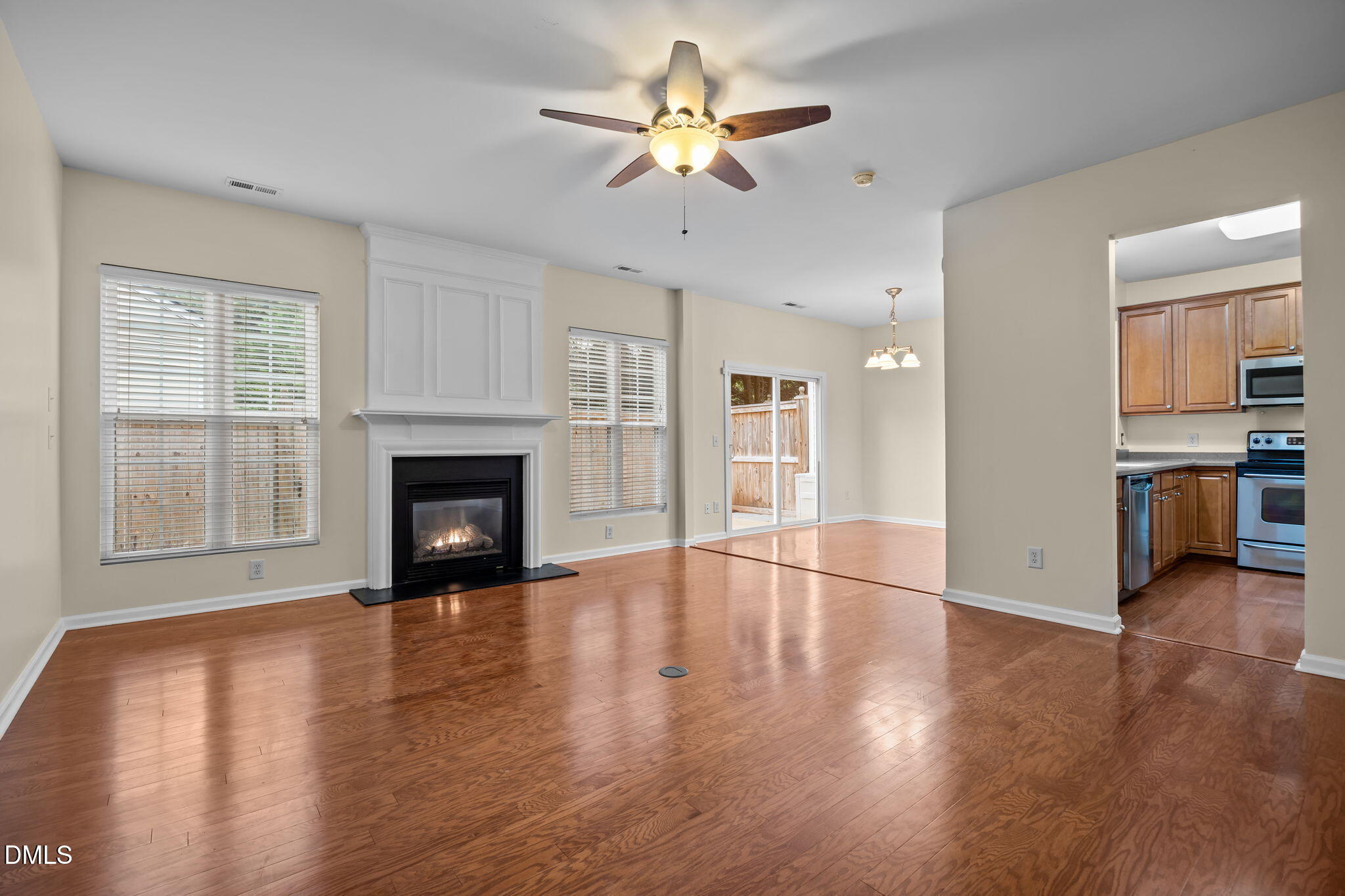 7805 Jeffrey Alan Court Raleigh, NC 27613 - Photo 9 of 46 a view of empty room with wooden floor and a fireplace