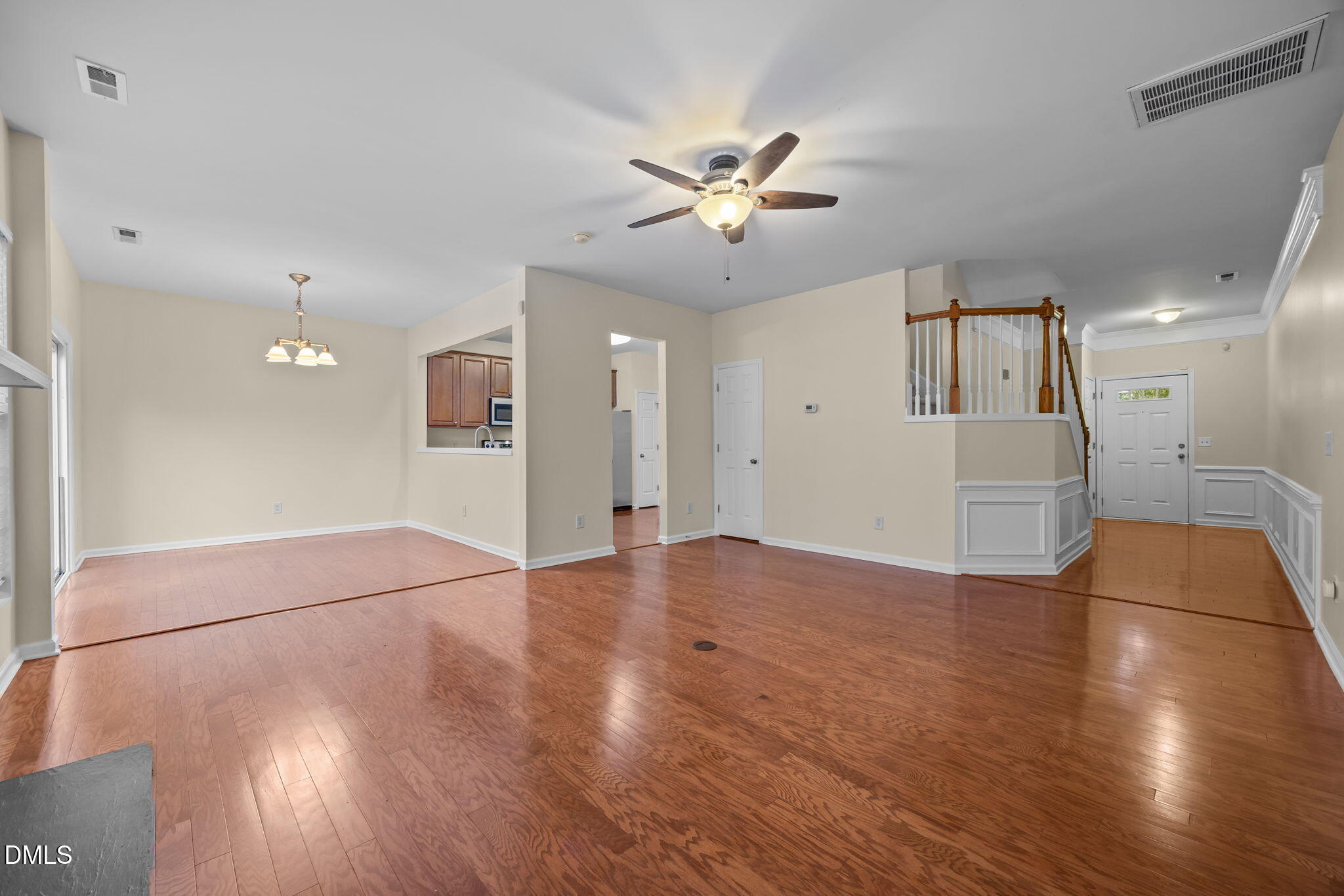 7805 Jeffrey Alan Court Raleigh, NC 27613 - Photo 10 of 46 a view of an empty room with wooden floor and a ceiling fan
