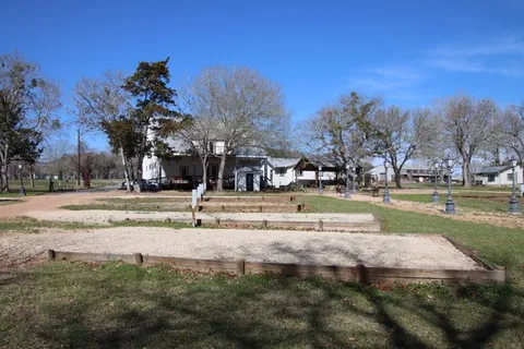 a view of outdoor space with garden and trees