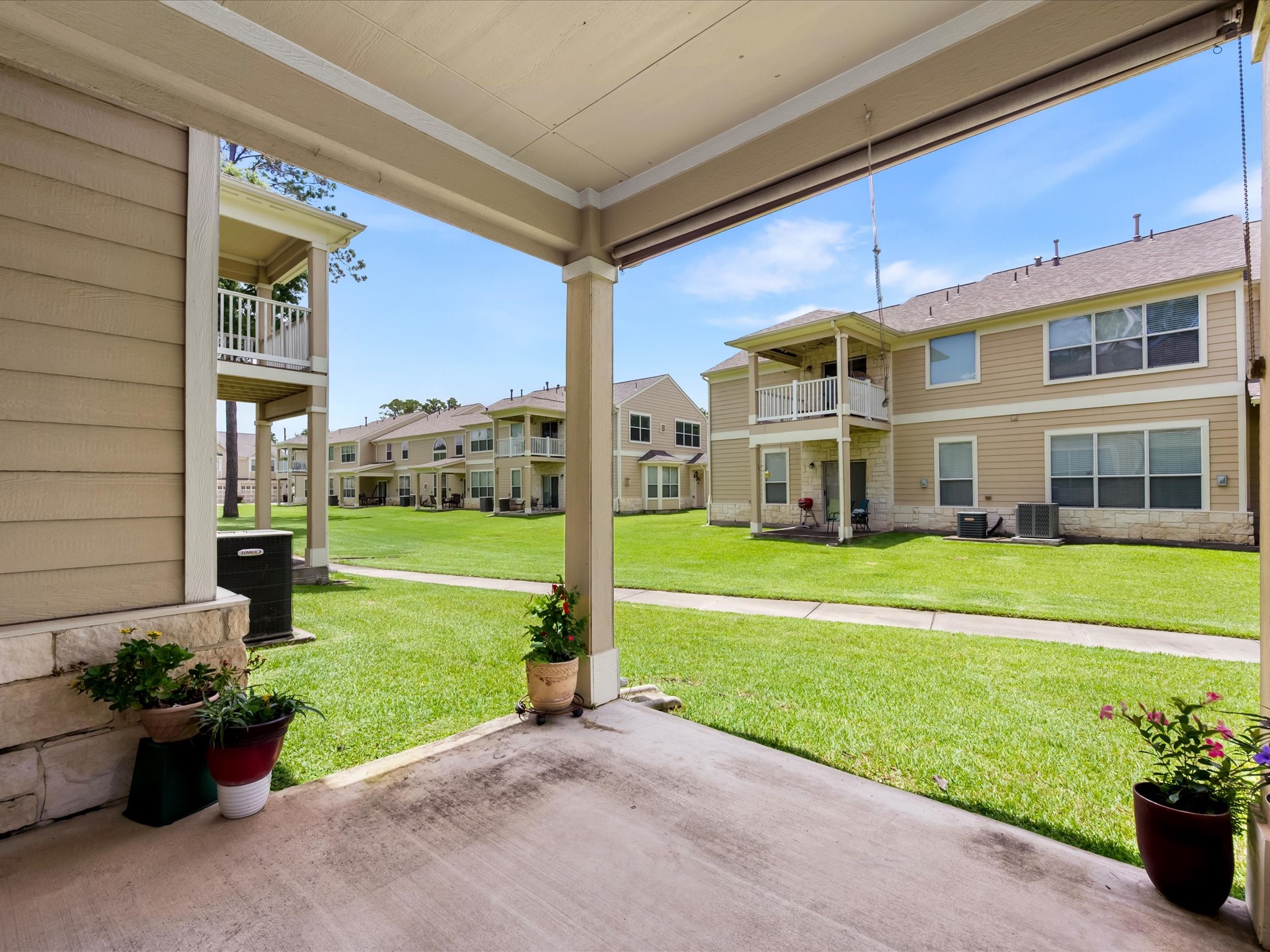 13600 Breton Ridge Street, Unit 31C Houston, TX 77070 - Photo 26 of 31 Enjoy a quiet moment outdoors beneath the covered patio, a comfortable extension of the home that offers space to relax and enjoy the fresh air.