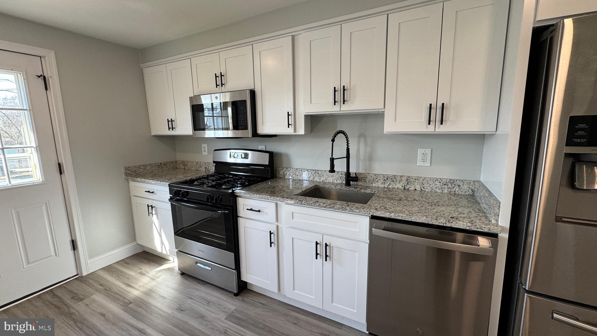 8029 Stratman Road Dundalk, MD 21222 - Photo 1 of 41 a kitchen with stainless steel appliances granite countertop refrigerator sink and cabinets
