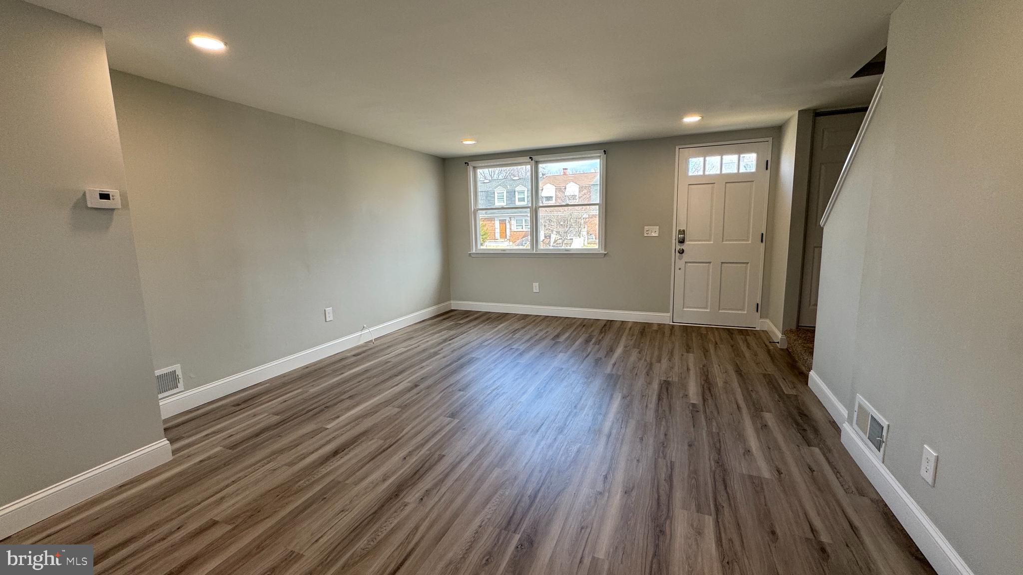 8029 Stratman Road Dundalk, MD 21222 - Photo 11 of 41 wooden floor in an empty room with a window