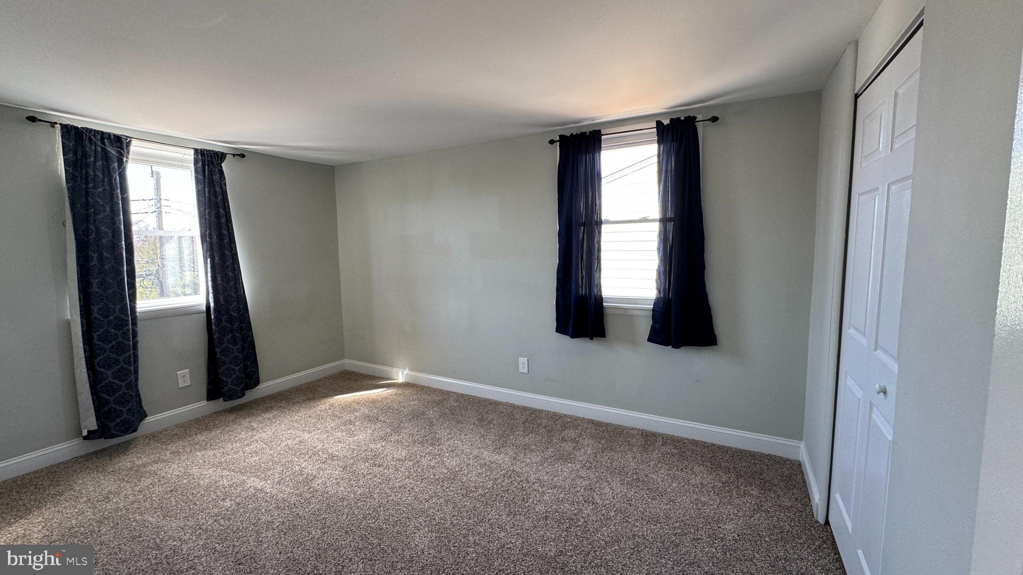 8029 Stratman Road Dundalk, MD 21222 - Photo 13 of 41 an empty room with windows and closet