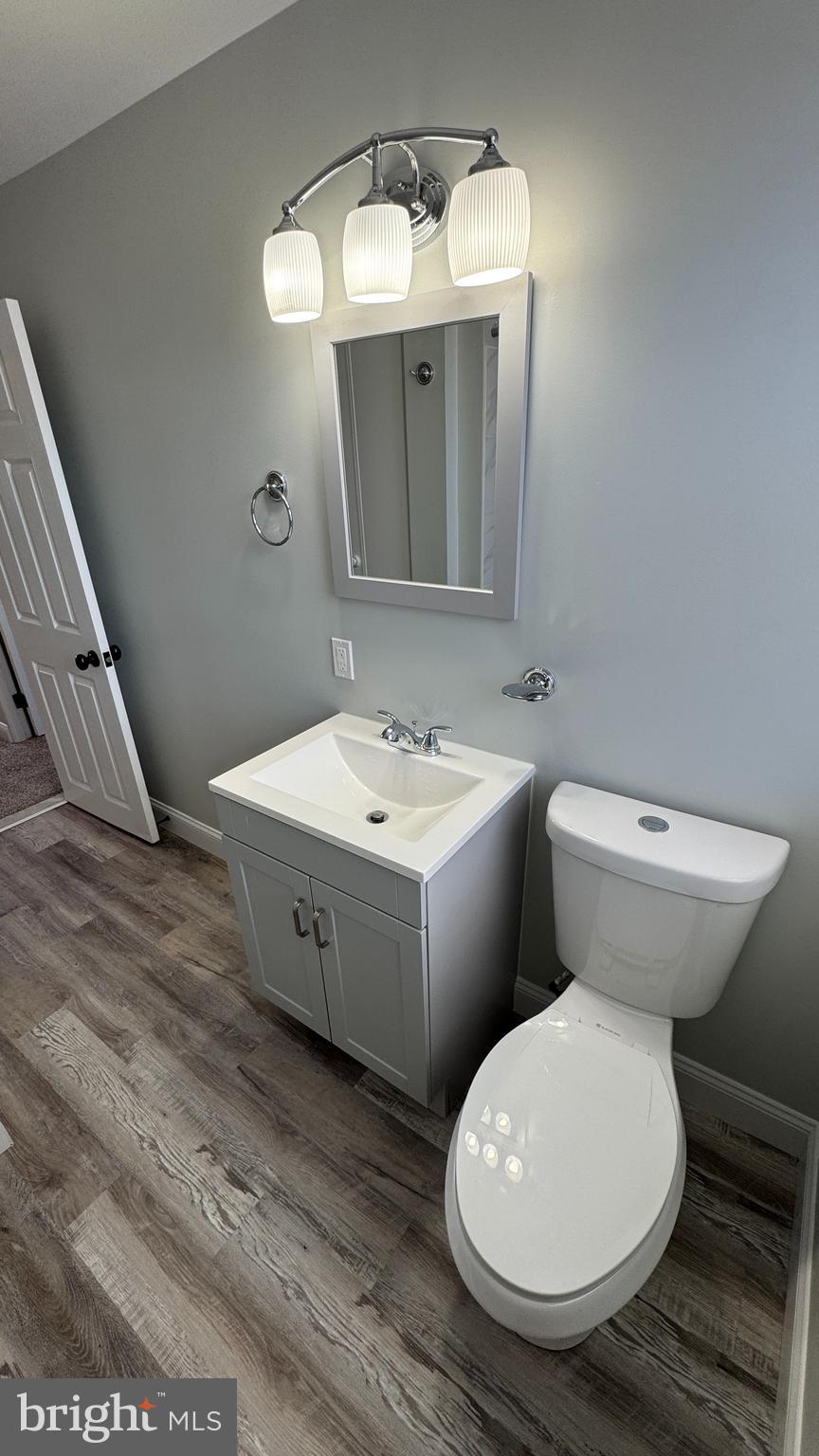 8029 Stratman Road Dundalk, MD 21222 - Photo 19 of 41 a bathroom with a toilet sink and mirror