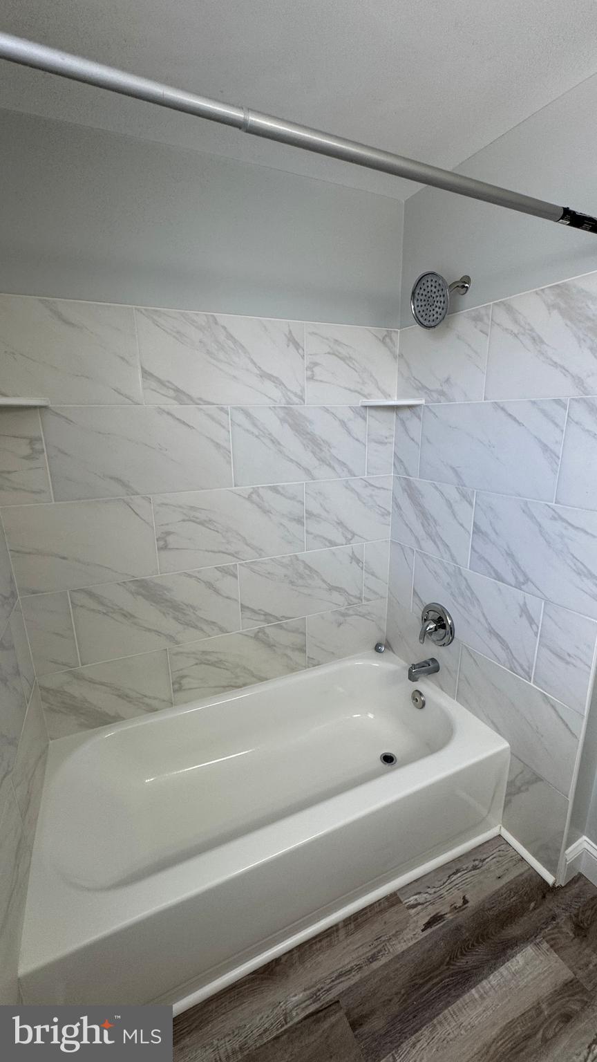 8029 Stratman Road Dundalk, MD 21222 - Photo 20 of 41 a bathroom with a bathtub and a shower