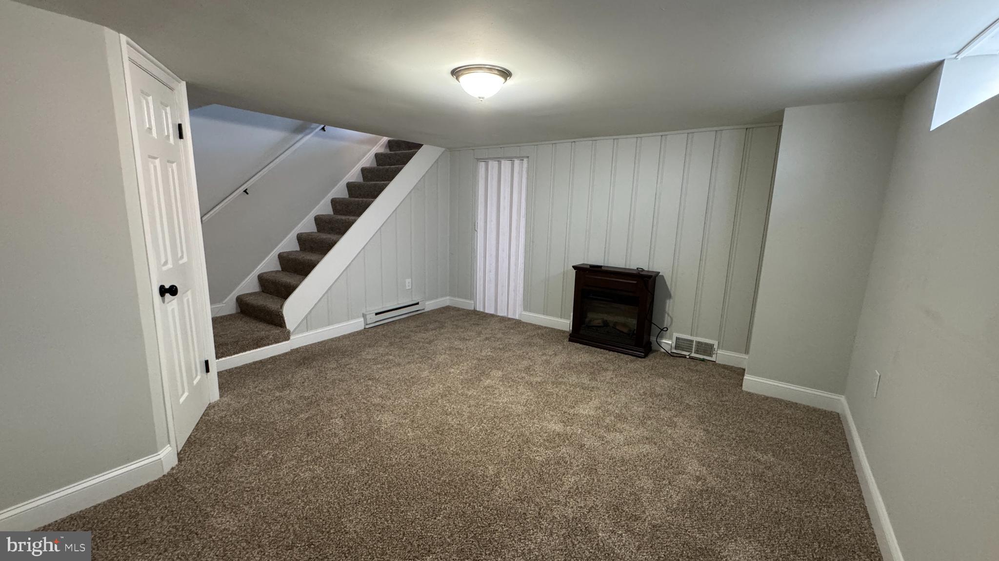 8029 Stratman Road Dundalk, MD 21222 - Photo 31 of 41 an empty room with a staircase and white walls