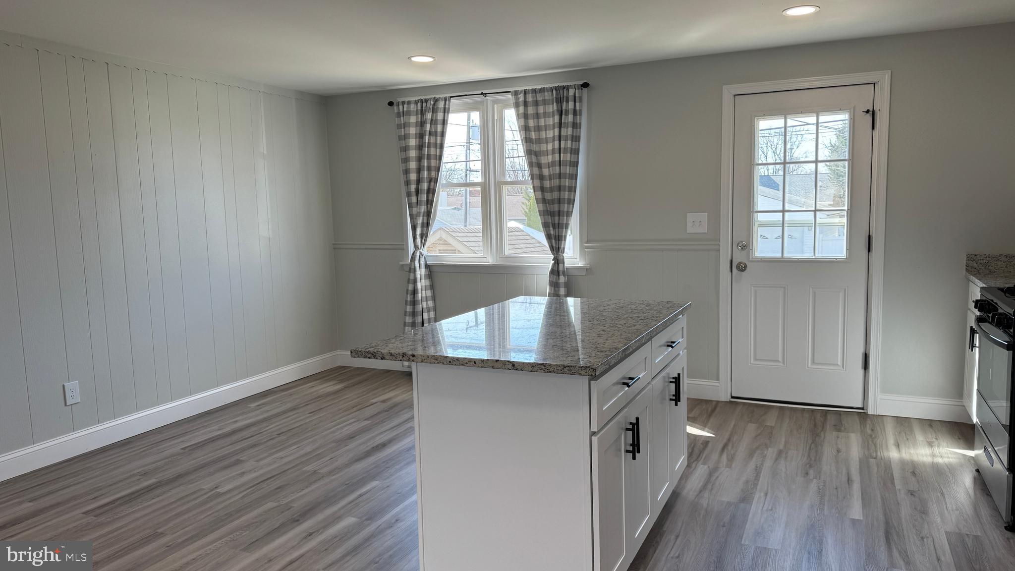 8029 Stratman Road Dundalk, MD 21222 - Photo 8 of 41 an empty room with wooden floor and windows