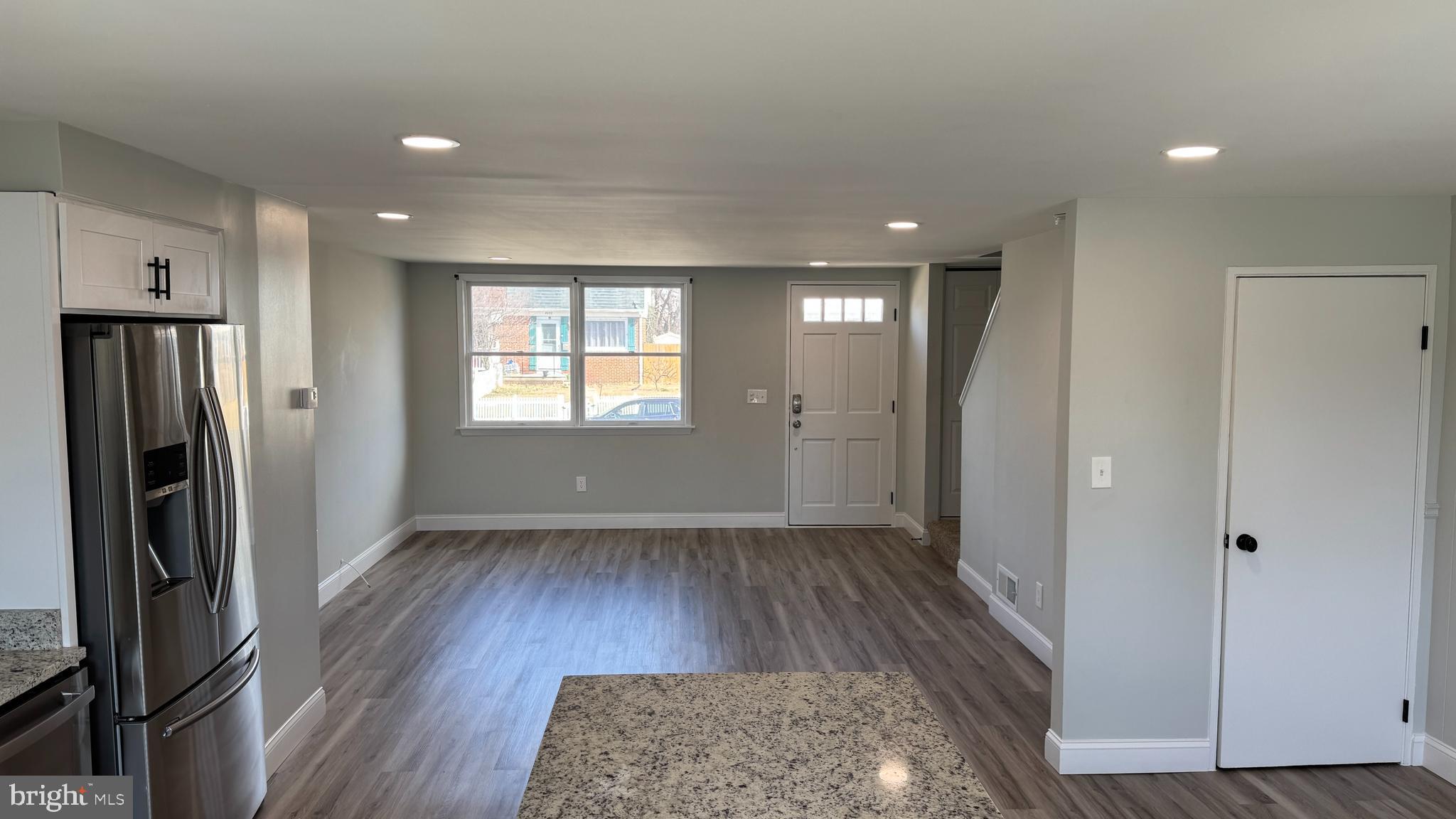 8029 Stratman Road Dundalk, MD 21222 - Photo 9 of 41 an empty room with wooden floor and a window