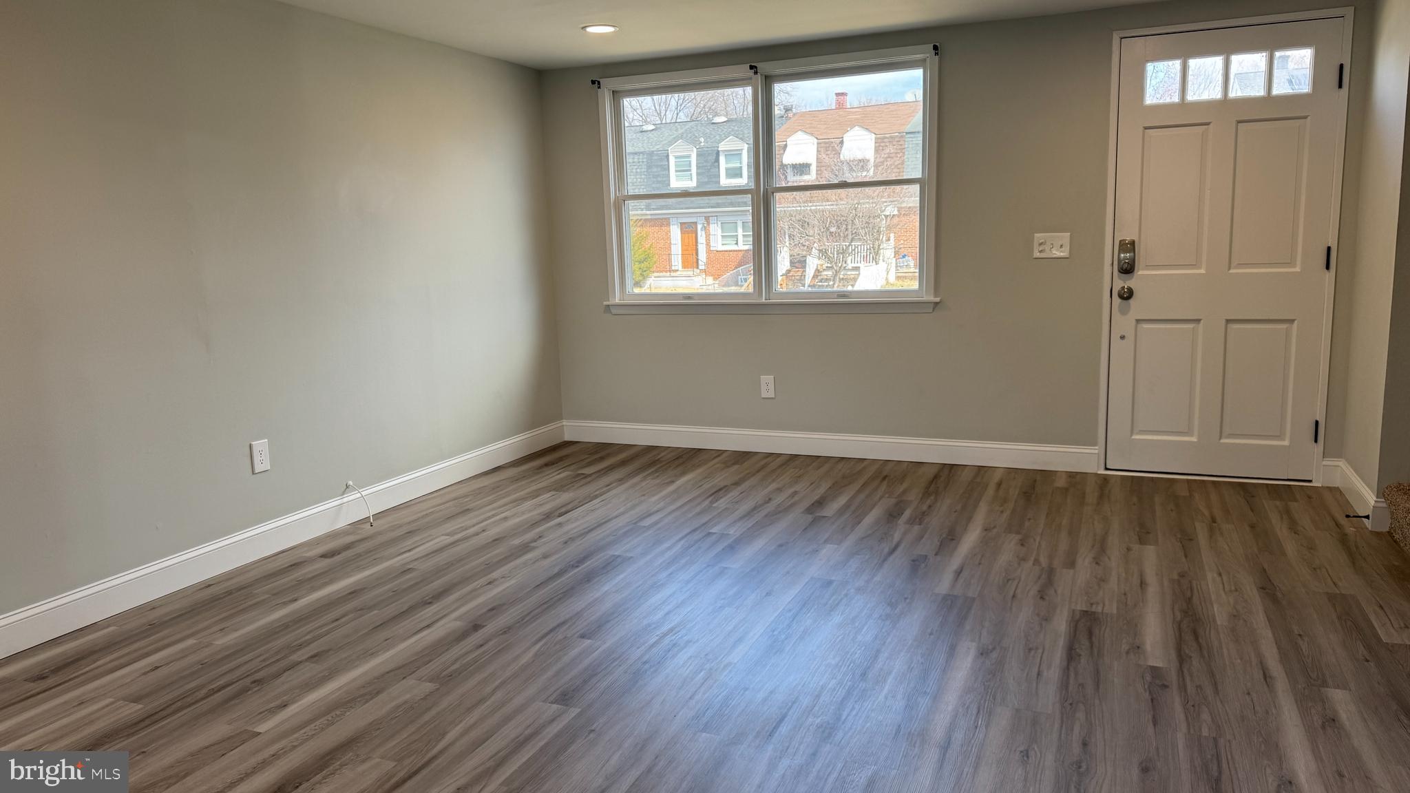 8029 Stratman Road Dundalk, MD 21222 - Photo 10 of 41 an empty room with wooden floor and windows