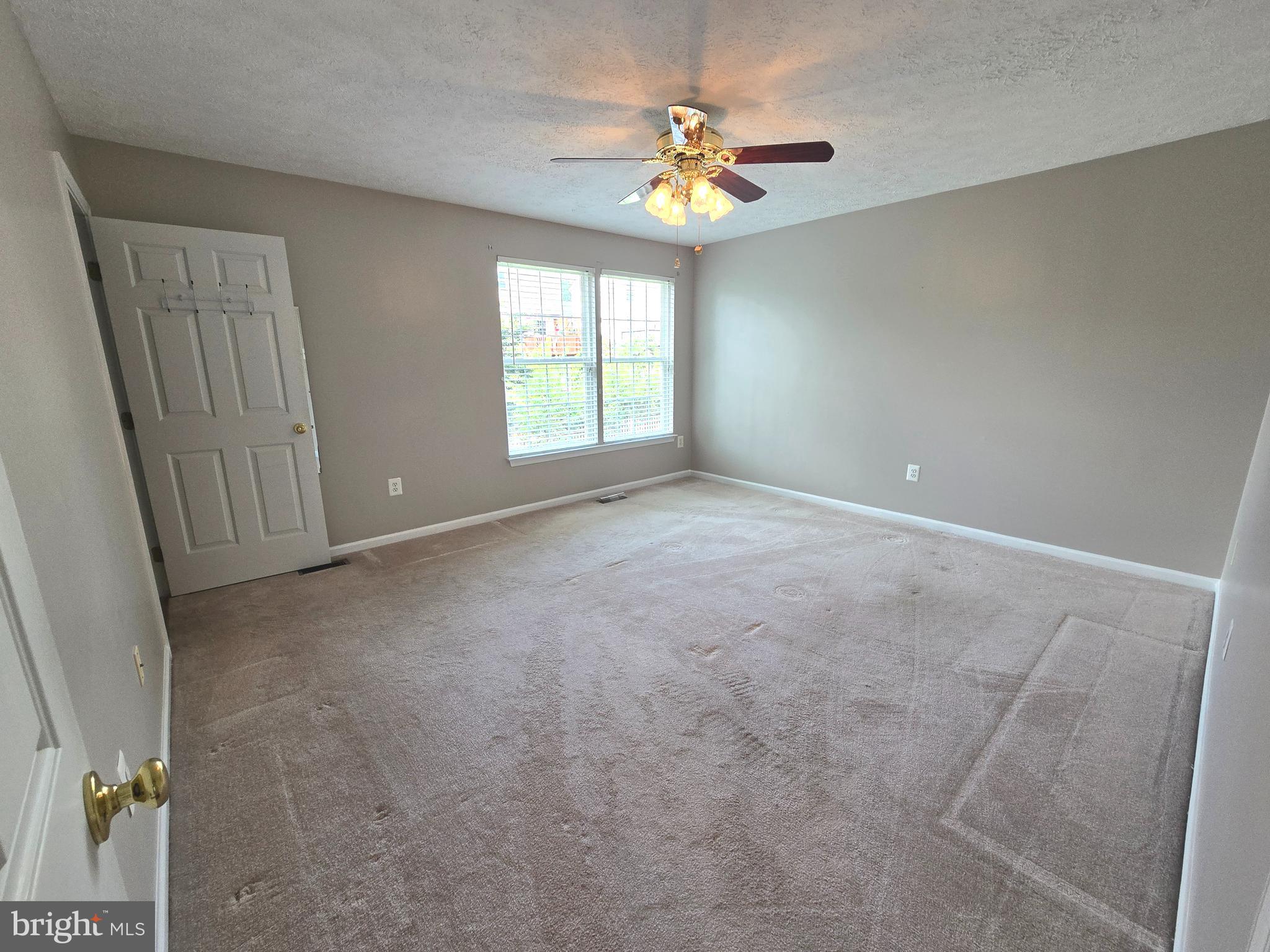 702 Jonathan Drive Joppa, MD 21085 - Photo 7 of 34 an empty room with windows and fan