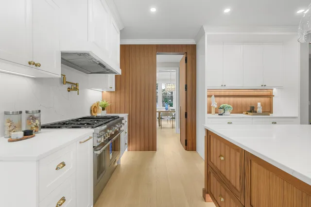 a stove top oven sitting inside of a kitchen
