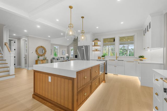 a living room with furniture a table and a large window