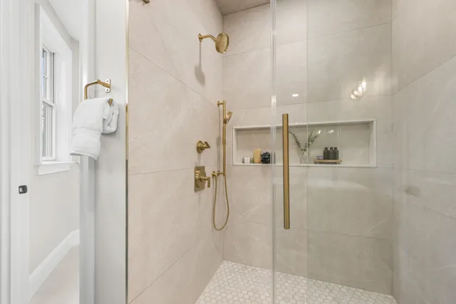 a bedroom with a large bed and a flat screen tv