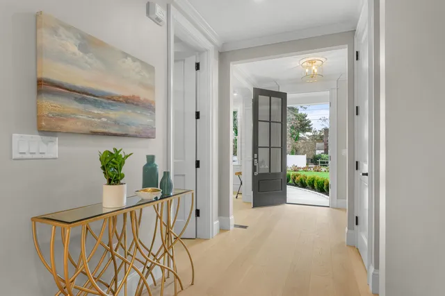 a view of a hallway and a livingroom with furniture