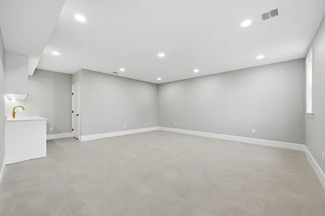 a picture of a room with a white wall and a painting