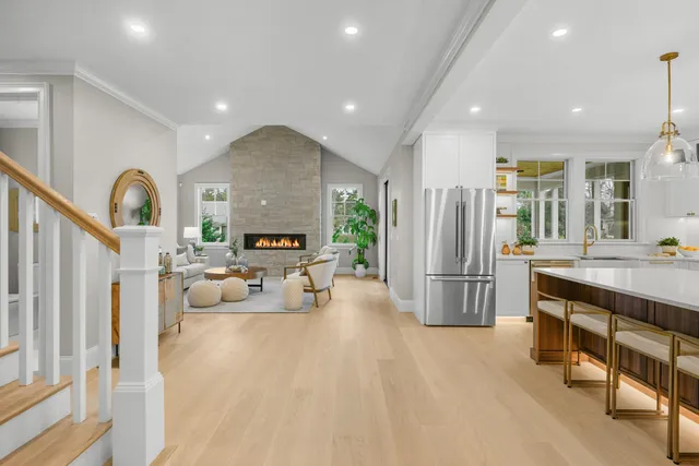a kitchen with kitchen island a stove a sink and a refrigerator