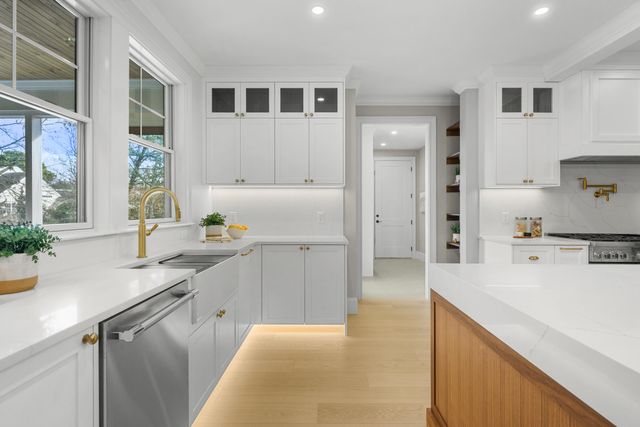 a stove top oven sitting inside of a kitchen