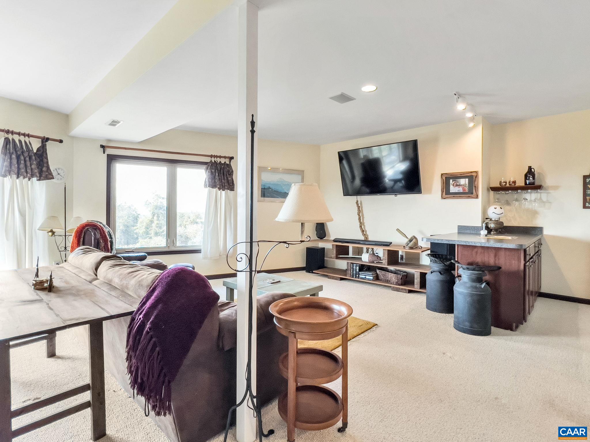 70 Percy Lane Fairfield, VA 24435 - Photo 38 of 52 a living room with furniture a flat screen tv and a large window
